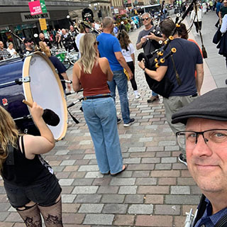 Photo by North Coast Pipe Band on August 17, 2023. May be an image of 8 people, clarinet, accordion, saxophone, tambourine, kilt, parasol, drum, drumstick, bowler hat and banjo.